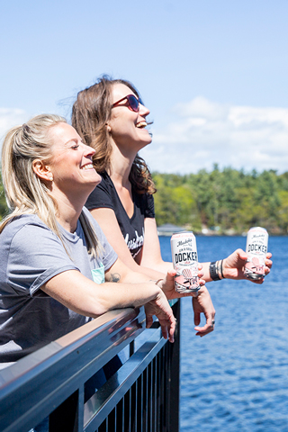 Girls laughing on a dock with DOcker Gin & Sodas in hand.