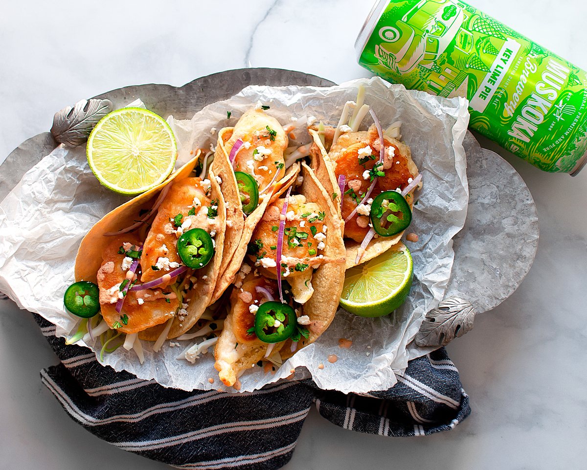 Tacos and beer with slices of lime
