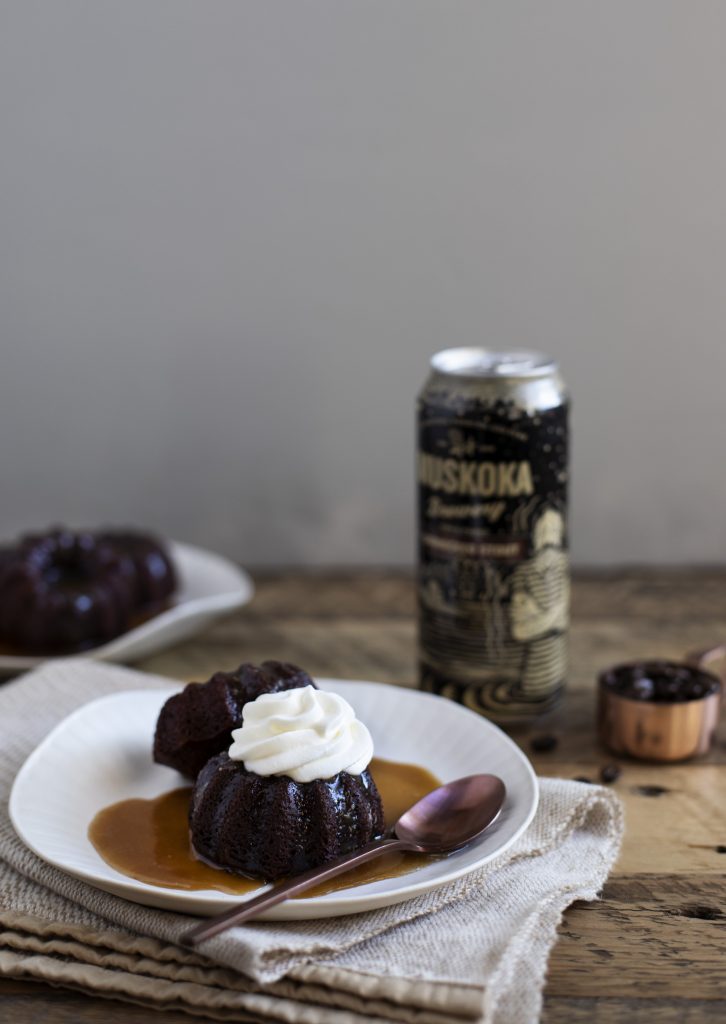 Sticky Pudding topped with whip cream, resting in toffee sauce witha can of Shinnicked Stout on the side.